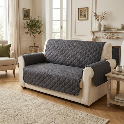 Le Jeté gris foncé sur un canapé 2 places crème